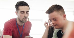 Teacher and student looking at a device together